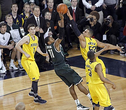 Michigan State's Keith Appling shoots over Jordan Morgan in the final seconds. That shot and an MSU follow don't go in.  (AP)
