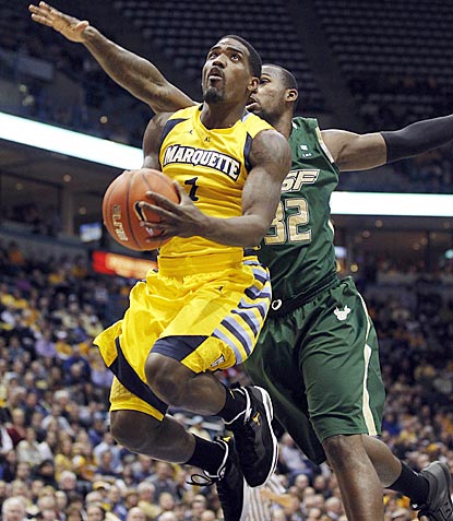 Marquette's Darius Johnson-Odom drives past South Florida's Toarlyn Fitzpatrick during the first half.  (AP)