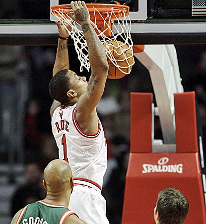 Derrick Rose slam dunks two of his season-high 34 points in the Bulls' 107-100 win over the Bucks. (AP)