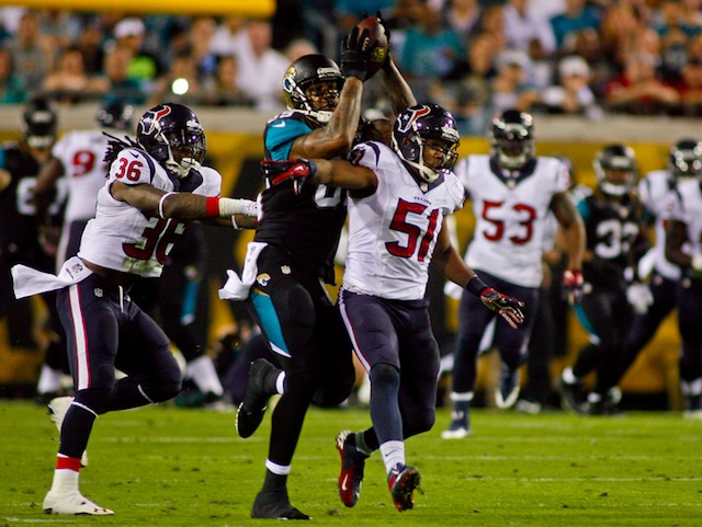 Marcedes Lewis reached over Darryl Sharpton to make this sweet catch in the first half on Thursday. (USATSI)