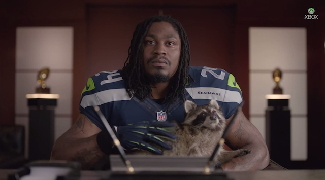 This is what Marshawn Lynch petting a raccoon looks like. (YouTube)