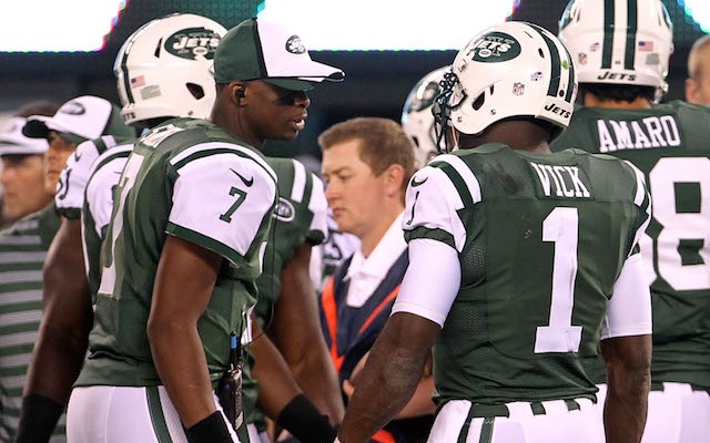 Michael Vick [right] has some advice for Geno Smith, 'Win now.' (USATSI)