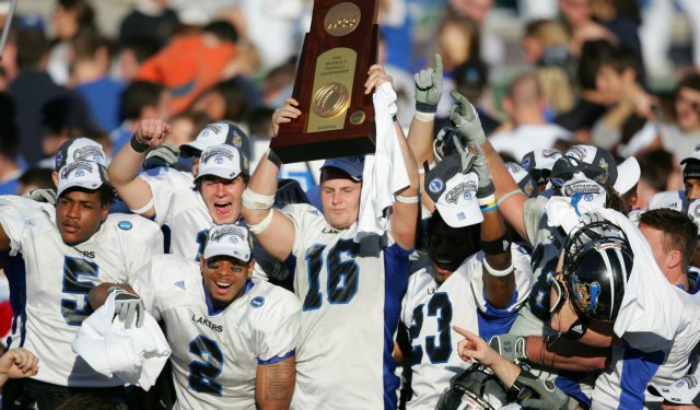 Cullen Finnerty, holding the Division II trophy, played in Baltimore and Denver. (USATSI)