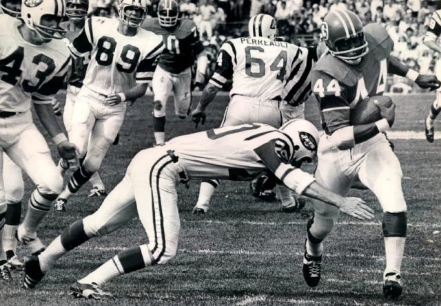 Steve O'Neal tries to tackle Denver's Floyd Little in 1969. (Getty Images)