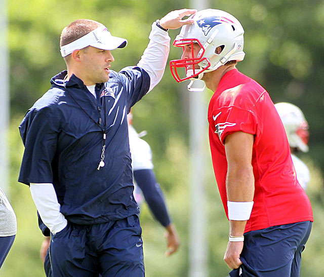 Reunited, former Broncos coach Josh McDaniels pats Tim Tebow on the helmet. (USATSI)