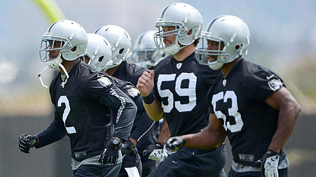 Veteran CB Charles Woodson (2) returns to the silver and black and leads the team on a run, including new acquisition Nick Roach, LB, formerly of the Bears (53). (USATSI)