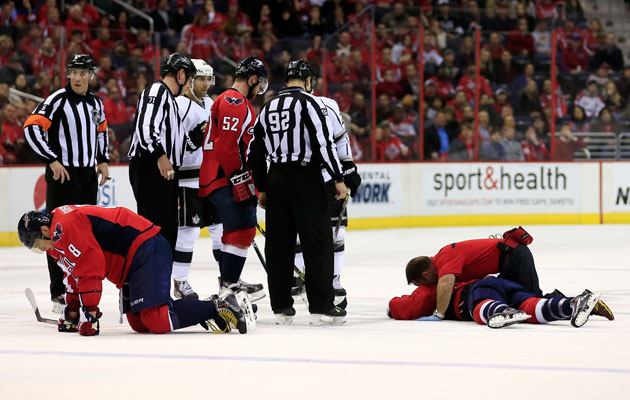 Alex Ovechkin and Jack Hillen stay down after their collision. (Getty Images)