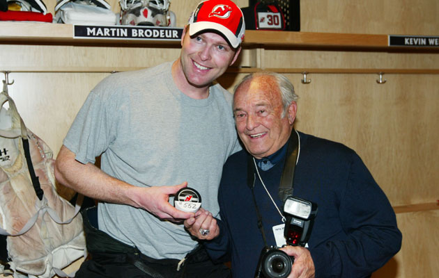 Martin Brodeur and father Denis pose for a picture with tools of their trades. (Getty Images)