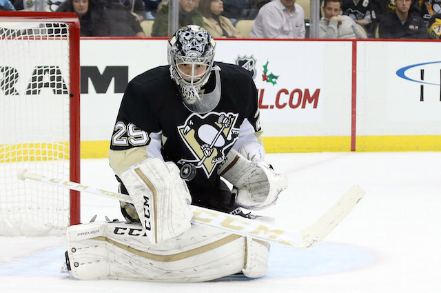 Pittsburgh Penguin goalie Marc-Andre Fleury blocks a shot in the first  period of the Penguins 5 to 3 win over the New York Rangers at the Mellon  Arena in Pittsburgh, Pennsylvania on
