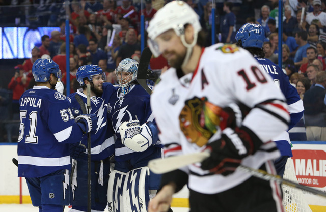 Patrick Sharp (10) skates by as the Lightning celebrate their Game 2 win. (USATSI)