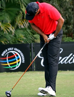 upswing, Tiger Woods gets legs kicked 
