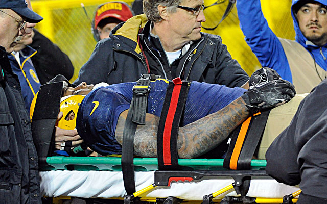 Jermichael Finley is carted off the field after suffering neck and spinal injuries against the Browns. (USATSI)