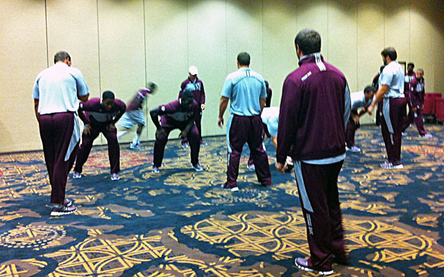 Texas A&M players go through formations and play calls in one of the hotel ballrooms. (CBSSports.com)