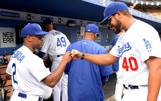 Guest manager Jimmy Rollins stuffs his belly to look like Tommy