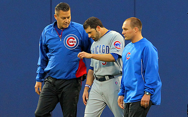 David DeJesus walks off the field Friday with athletic trainers.