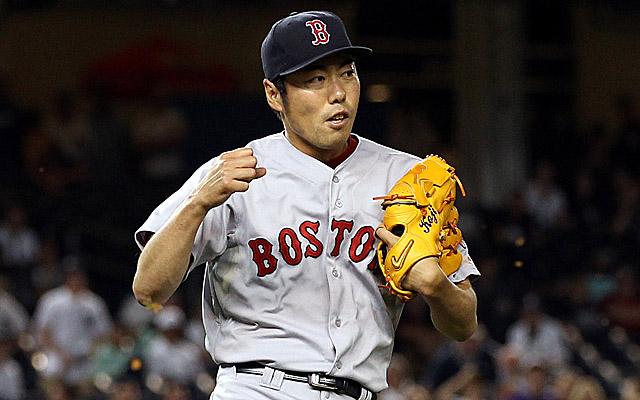 Boston Red Sox closer Koji Uehara holds his son Kazuma as they celebrate on  the field after the Red Sox won the 2013 World Series defeating the St.  Louis Cardinals in game