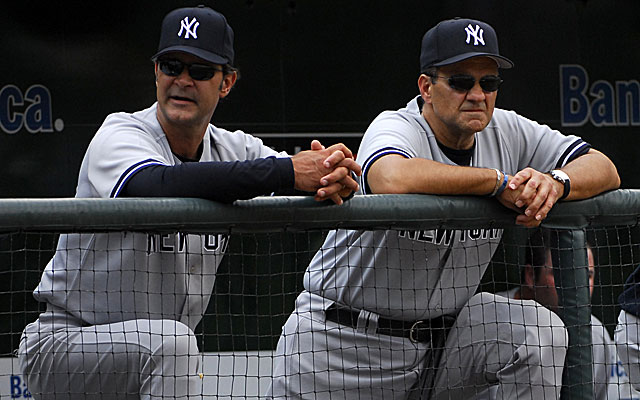 30 July 2013: Yankees manager Joe Girardi and his son Dante Girardi take a  photo with Dodgers manager Don Mattingly prior a Major League Baseball  interleague game between the New York Yankees