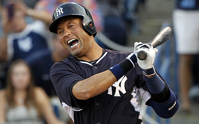 New York Yankees Derek Jeter looks at his bat before stepping into