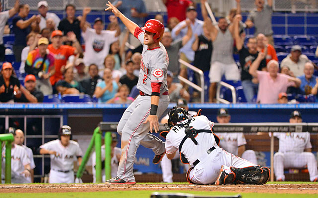 Zack Cozart is tagged out by Jeff Mathis at the plate in a call that is eventually overturned. (USATSI)