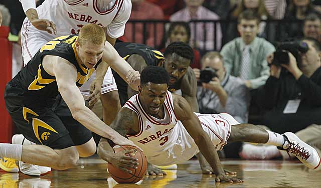 Iowa's Aaron White and Nebraska's Benny Parker get on the floor after the ball. (USATSI)