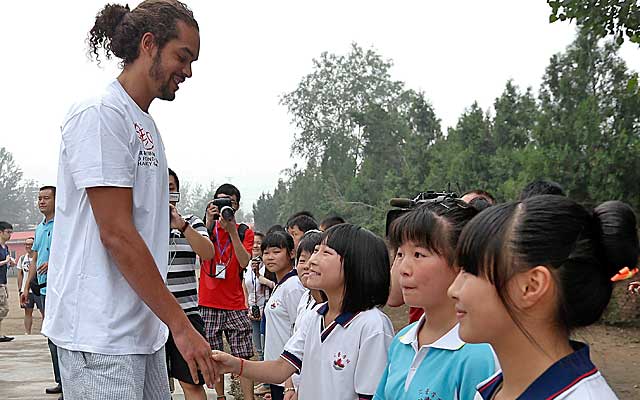 Noah greets children at a school during a trip to China in the offseason.    (Getty Images)