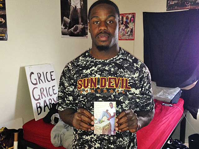 Marion Grice holds a photo of Joshua Woods. The two friends called each other brother. (Jeremy Fowler photo)