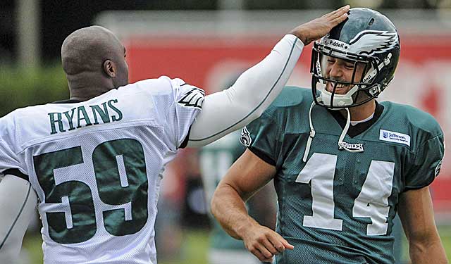 DeMeco Ryans gives Riley Cooper a pat on the helmet, welcoming back the troubled wide receiver. (USATSI)