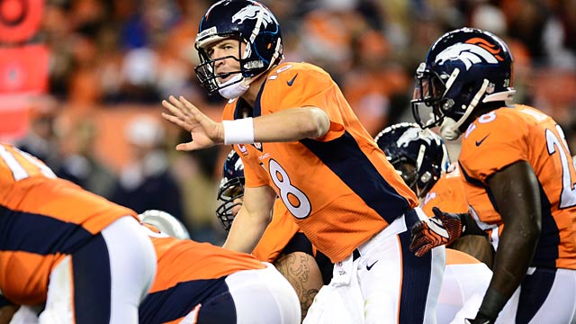 Denver Broncos huddle during the first half of an NFL football