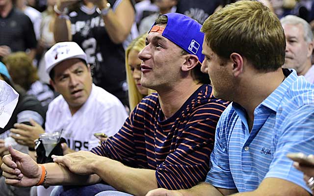 Johnny Manziel watches his pal LeBron James while sitting courtside during Game 2 of the NBA Finals.     (USATSI)