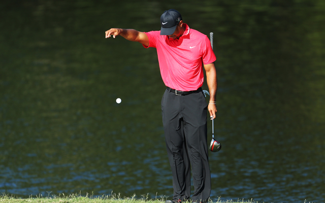 Tiger Woods makes a drop on Sunday at the Players Championship (Getty Images)